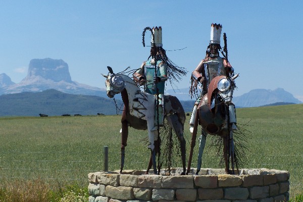 North Entrance to the Blackfeet Indian Reservation with Chief Mountain in the background.  Metal warriors by Jay Labor, enrolled member of the Blackfeet Nation